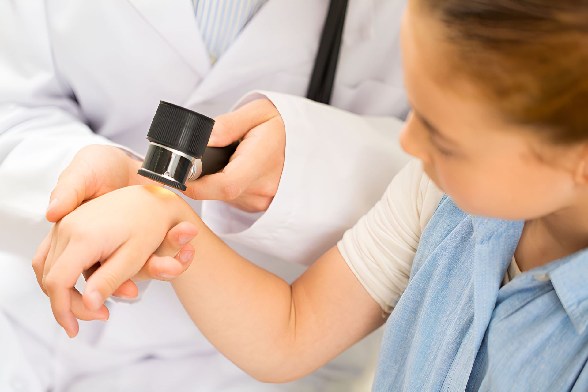 A Doctor is Examining a Child 's Arm — Newcastle Paediatric Occupational Therapy in Swansea, NSW