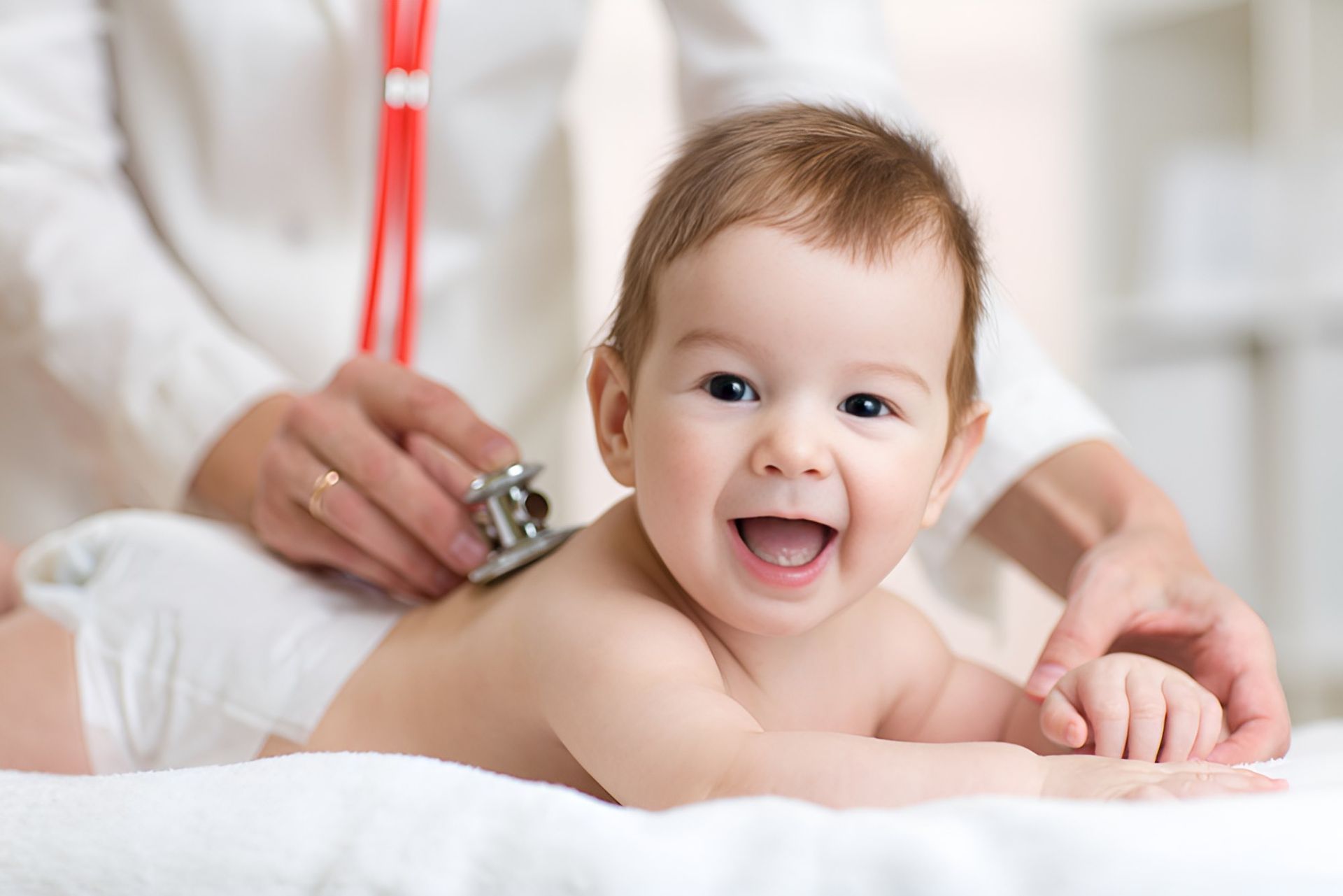 A Baby is Being Examined by a Doctor With a Stethoscope— Newcastle Paediatric Occupational Therapy In Floraville, NSW