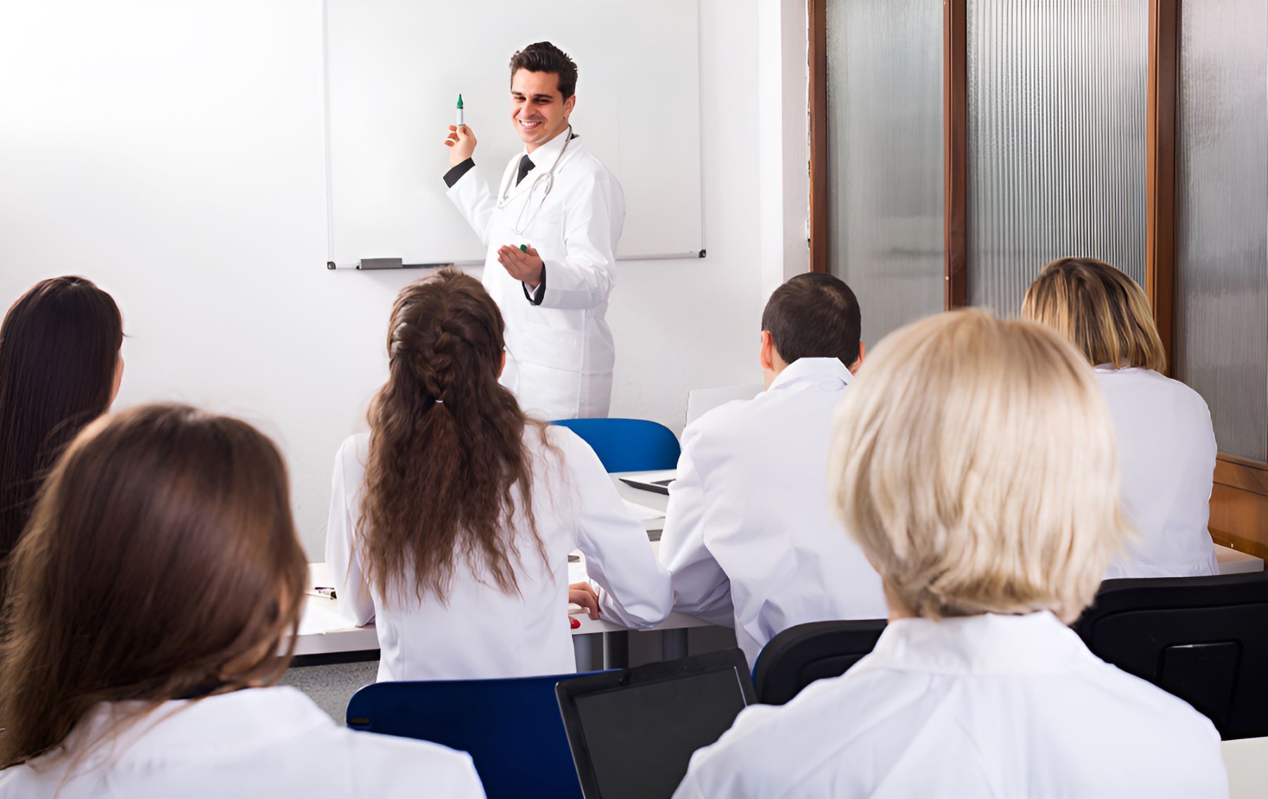 A Group of Doctors Are Sitting in a Classroom — Newcastle Paediatric Occupational Therapy In Floraville, NSW