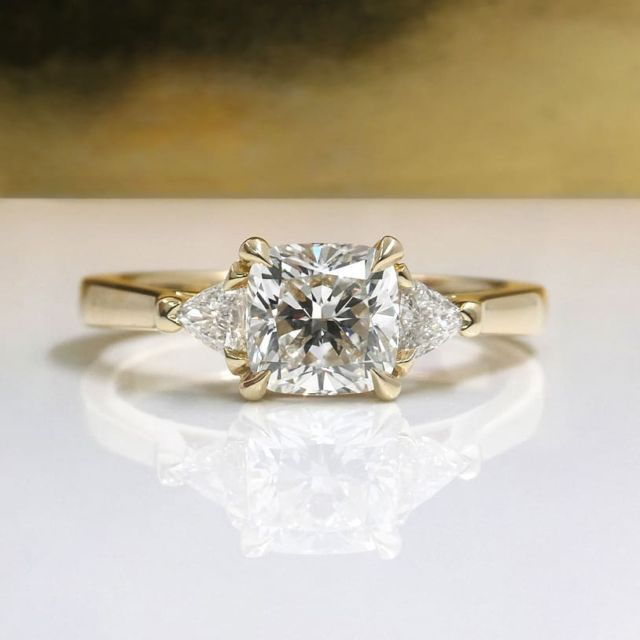 Kimberfire cushion trilliant three stone engagement ring