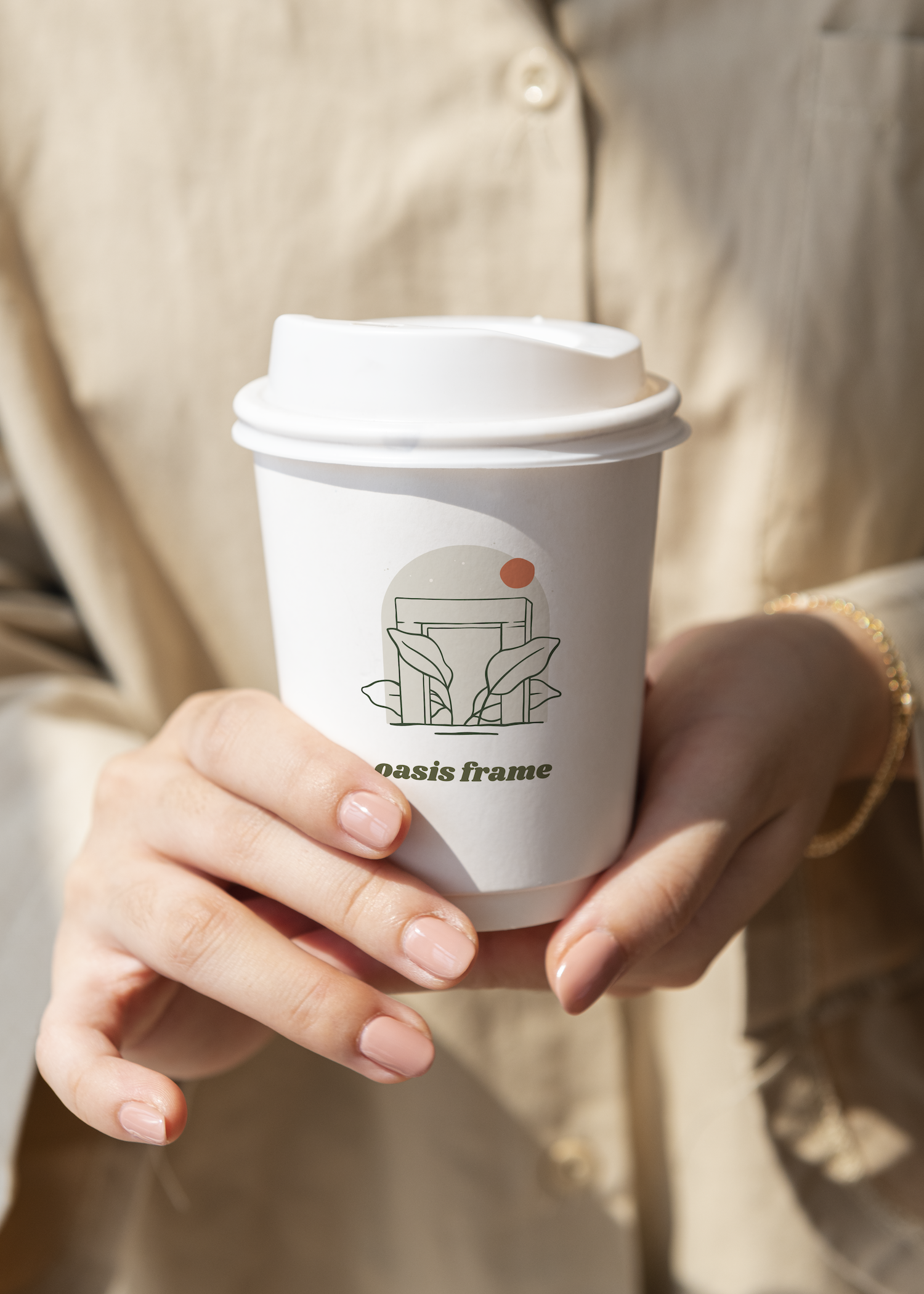 A person is holding a cup of coffee in their hands.