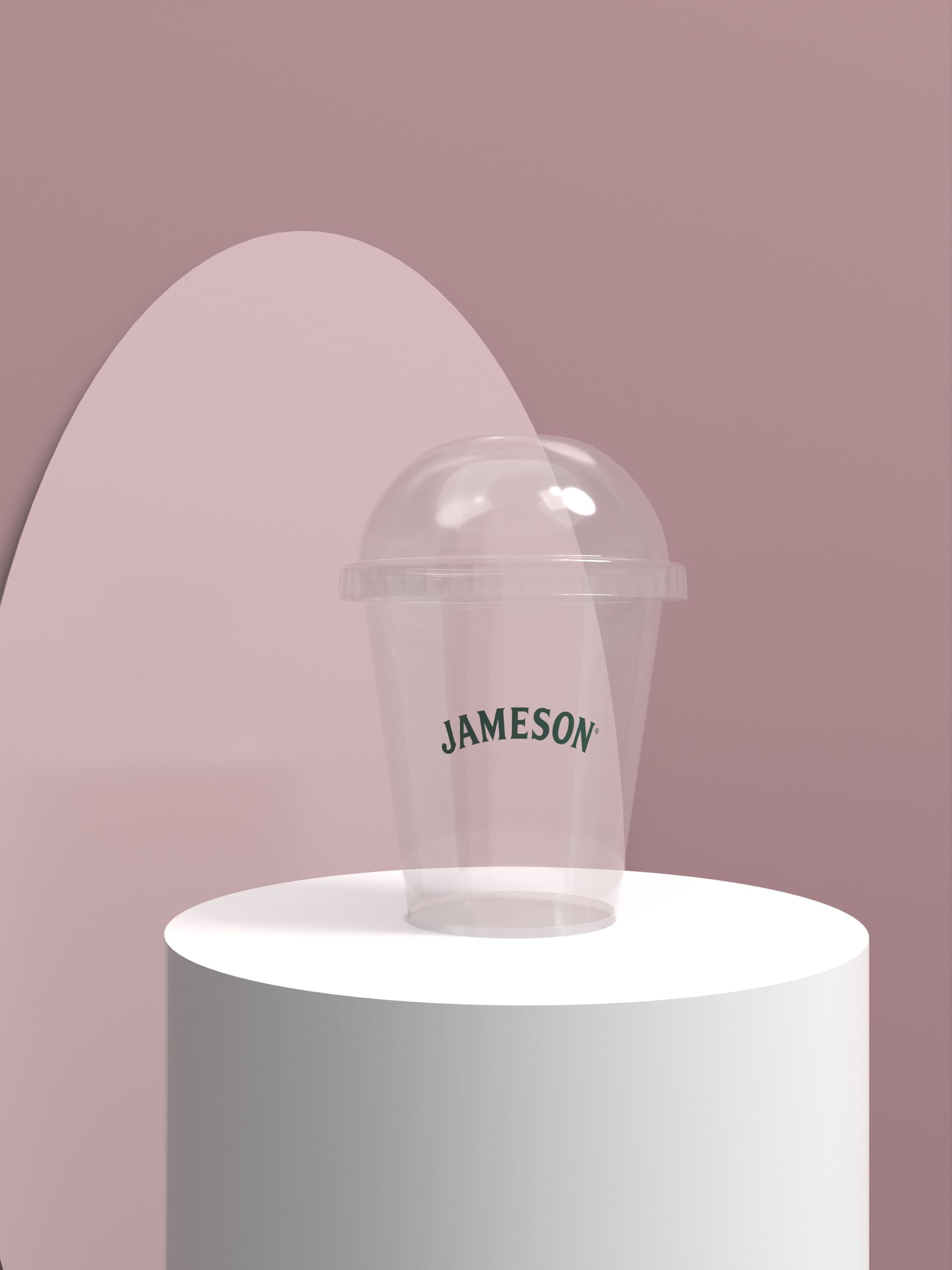 A jameson cup is sitting on top of a white cylinder.