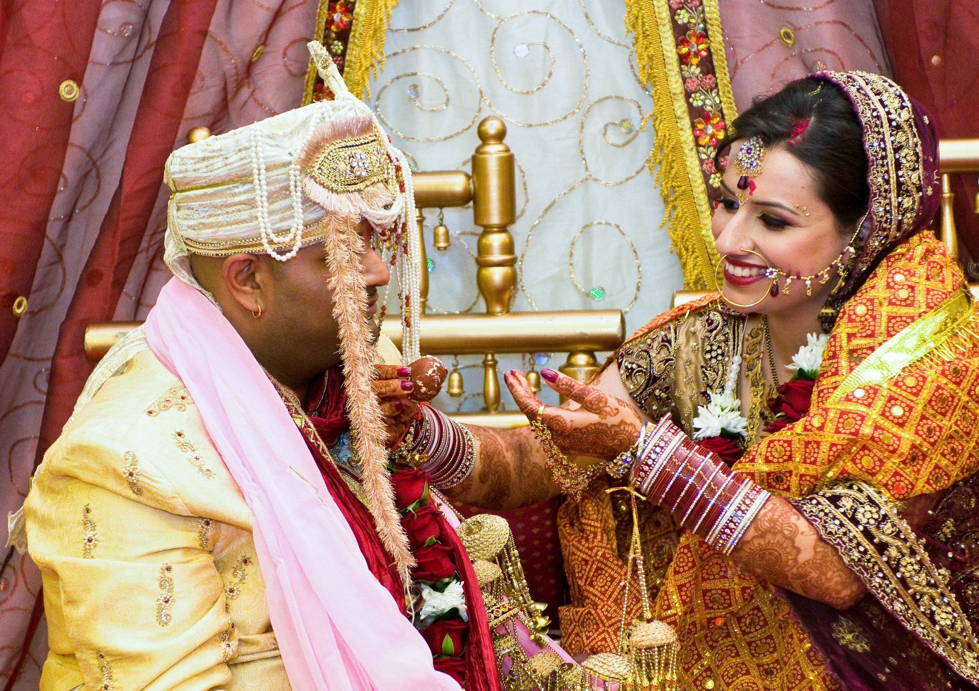 Hindu custom bride feeds her husband with sweet delacasies