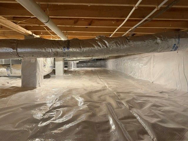 Concrete pouring from a chute onto a sidewalk.