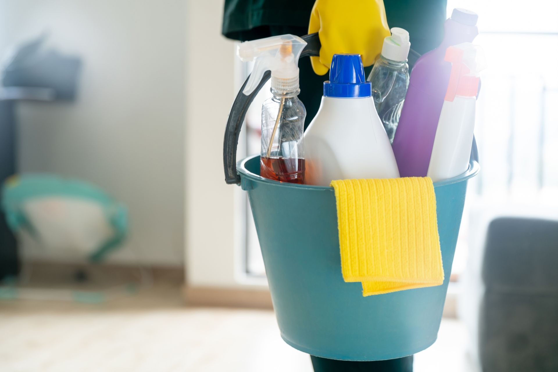 Close-up of a cleaner holding supplies for move in cleaning services.