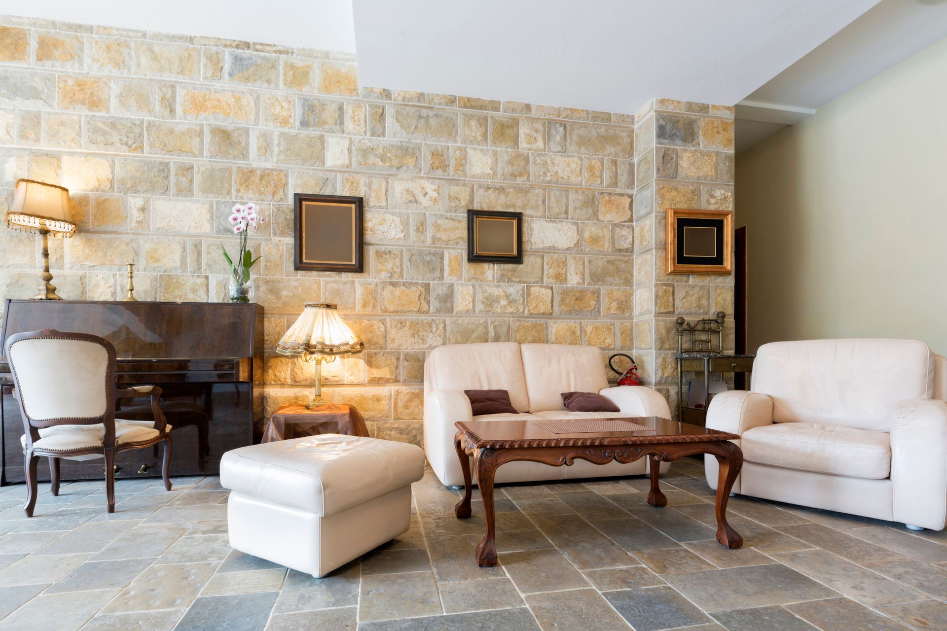 A living room with a couch, chairs, coffee table and fireplace | Louisville, KY | S & S Concrete Inc.