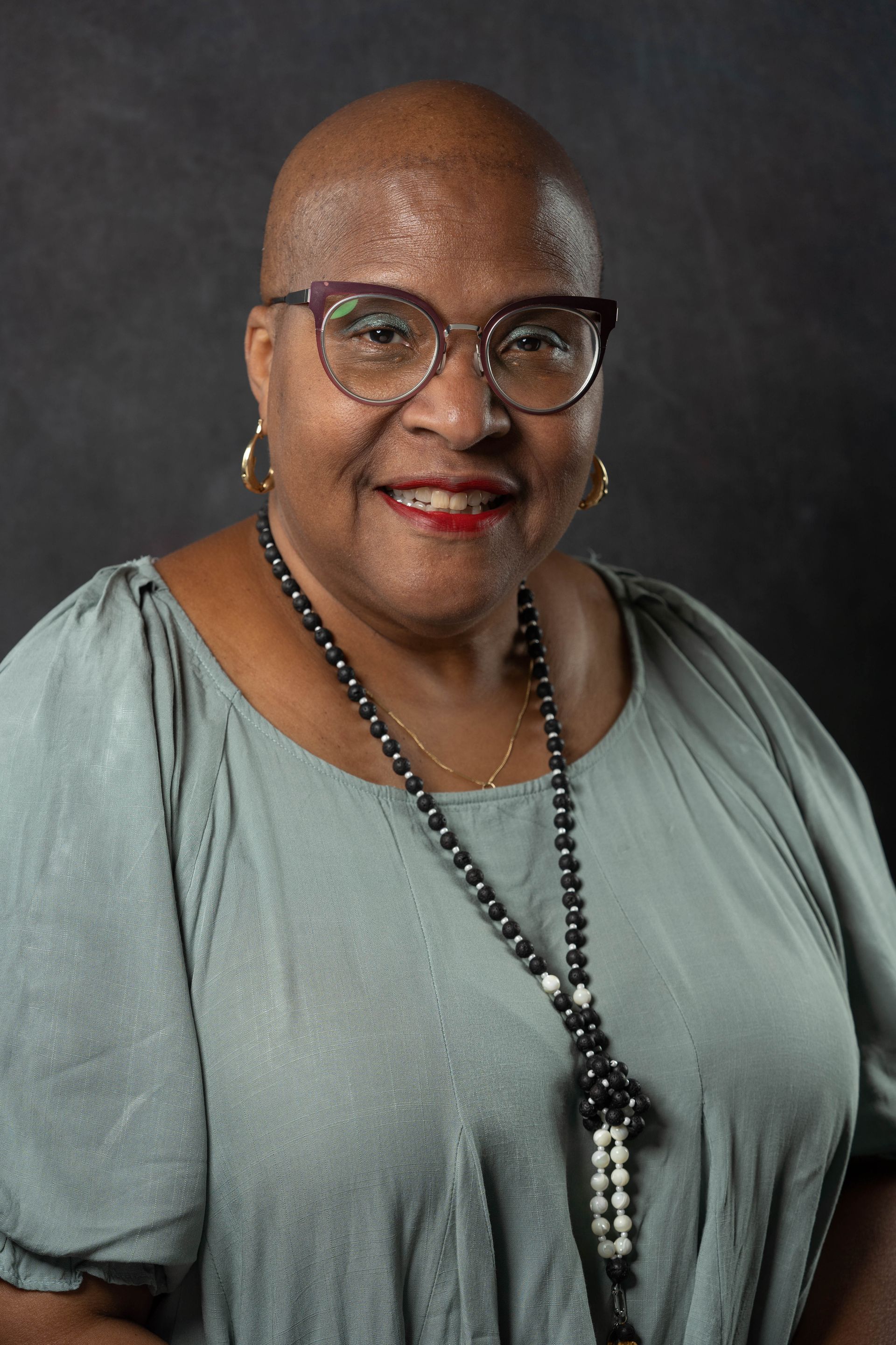 Older black woman wearing a light pink shirt