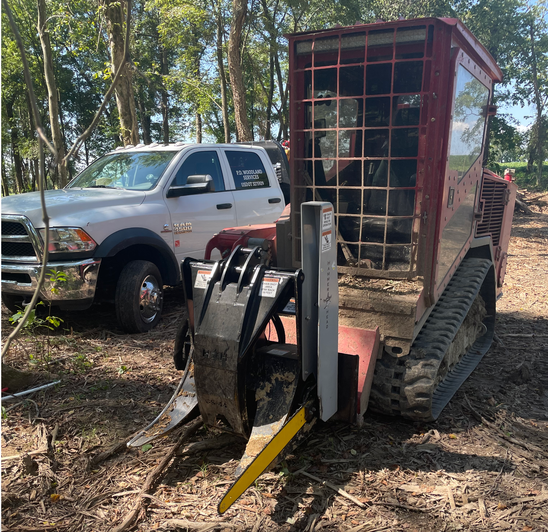 A ram truck is parked next to a bulldozer