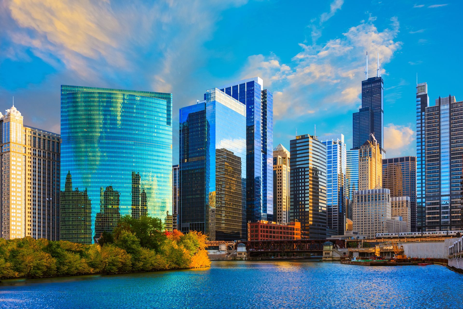 A city skyline with a body of water in the foreground.