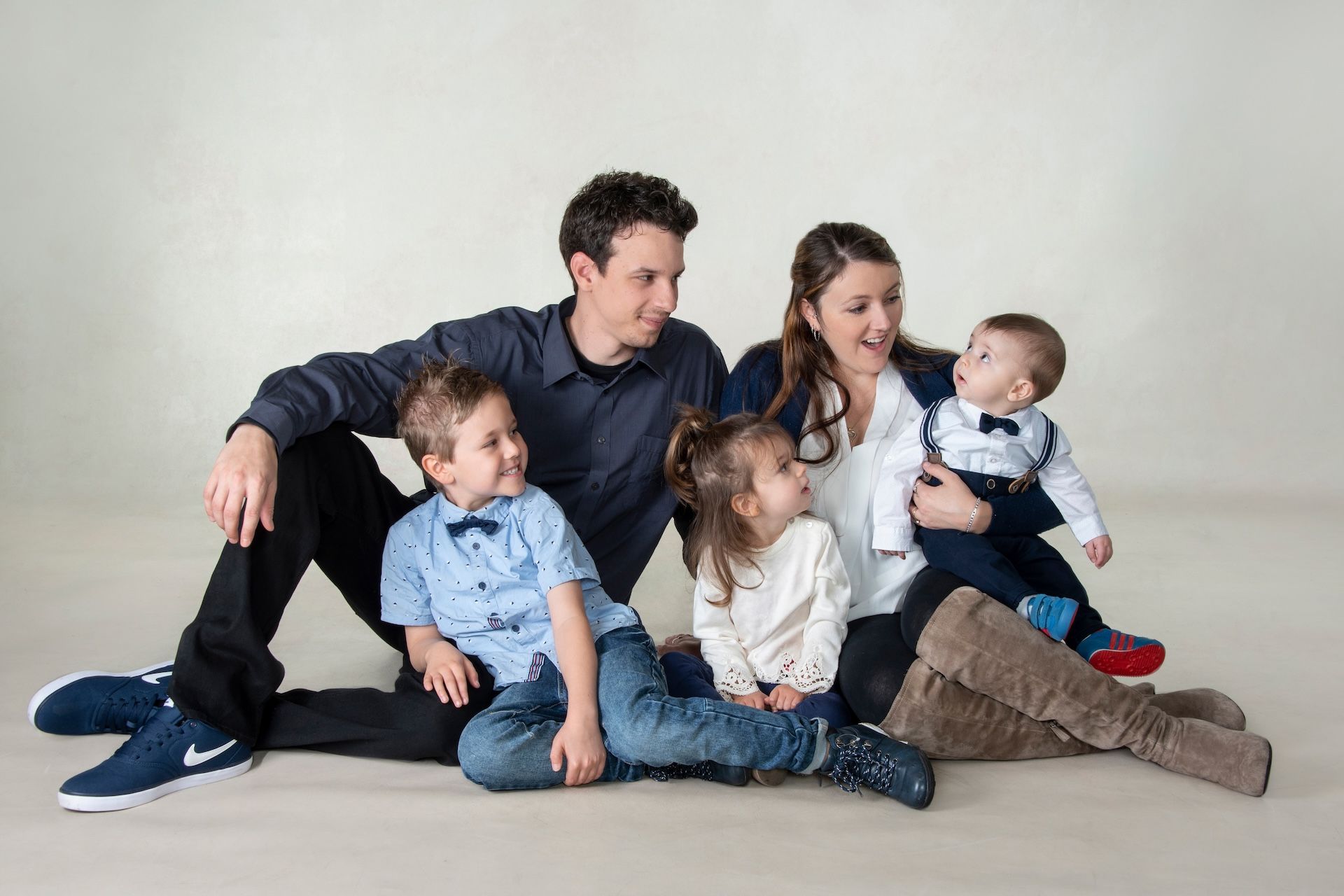 A Family is Posing for a Picture While Laying on the Floor — Dale Wright Portrait Maker in Wangaratta, VIC