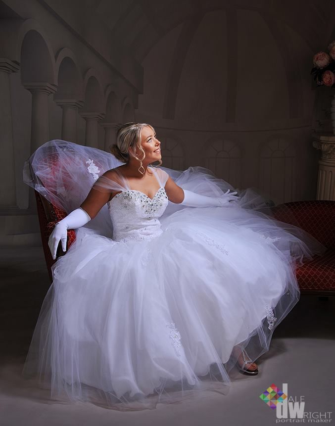 A Woman in a White Dress and Gloves is Sitting on a Couch — Dale Wright Portrait Maker in Shepparton, VIC