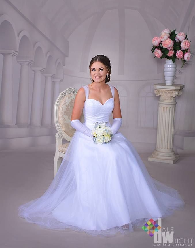 A Woman in a White Dress is Sitting in a Chair Holding a Bouquet of Flowers — Dale Wright Portrait Maker in Shepparton, VIC