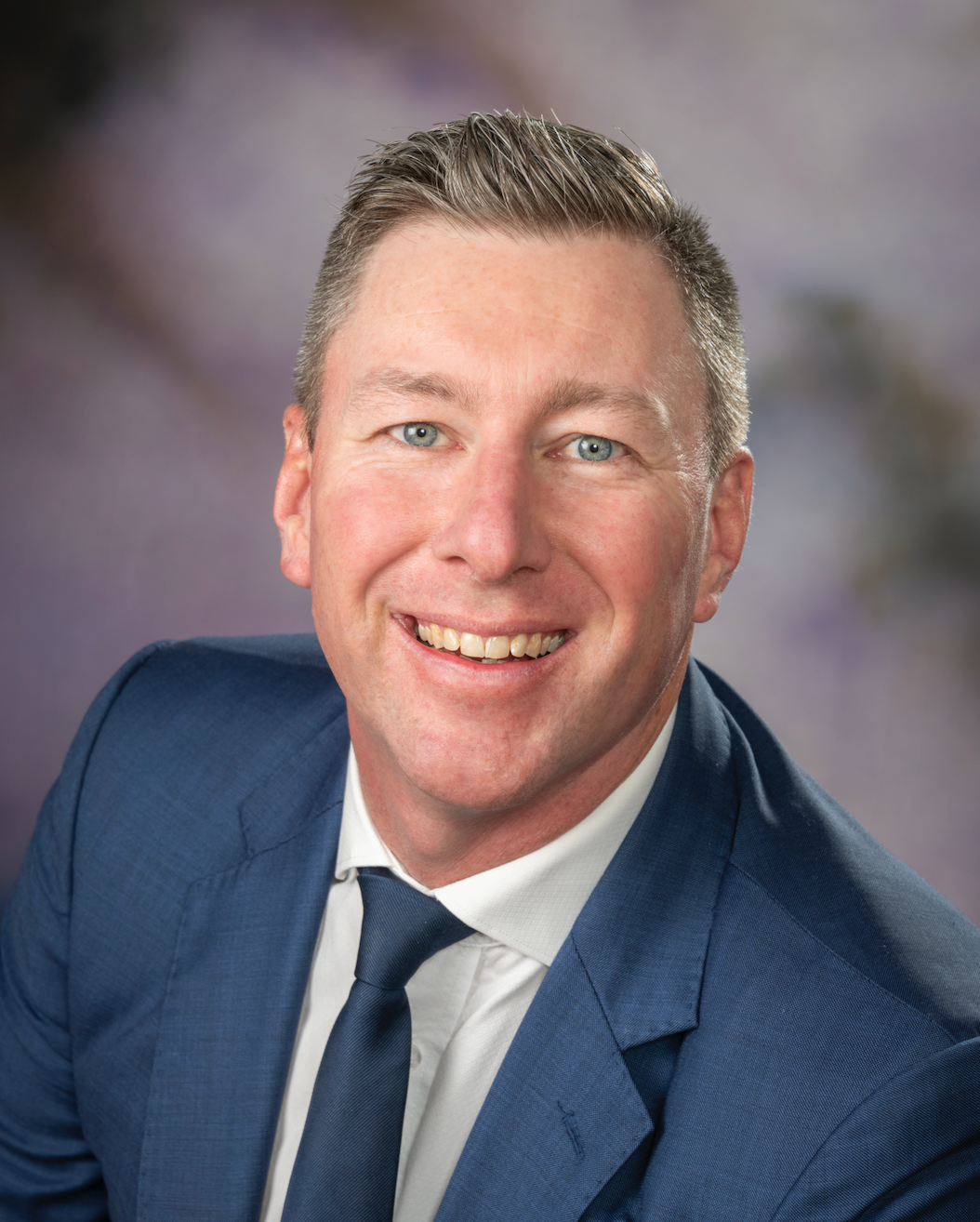 A Woman in a Black Jacket is Smiling for the Camera — Dale Wright Portrait Maker in Shepparton, VIC