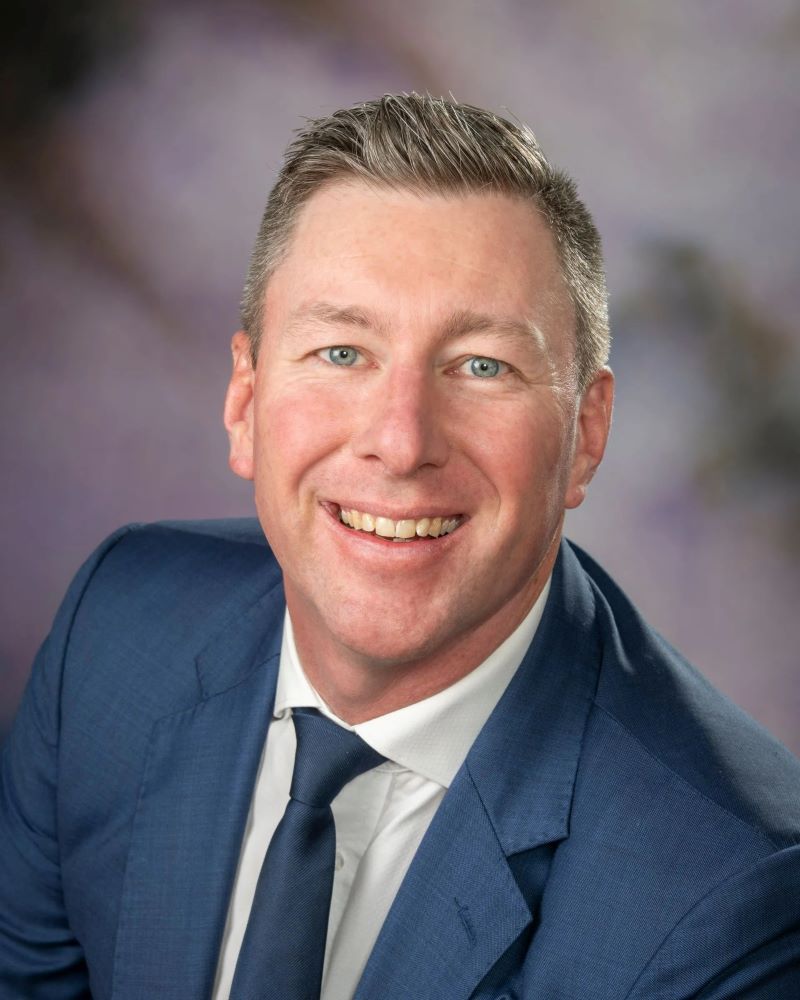 A Man in a Suit and Tie is Smiling for the Camera — Dale Wright Portrait Maker in Wangaratta, VIC