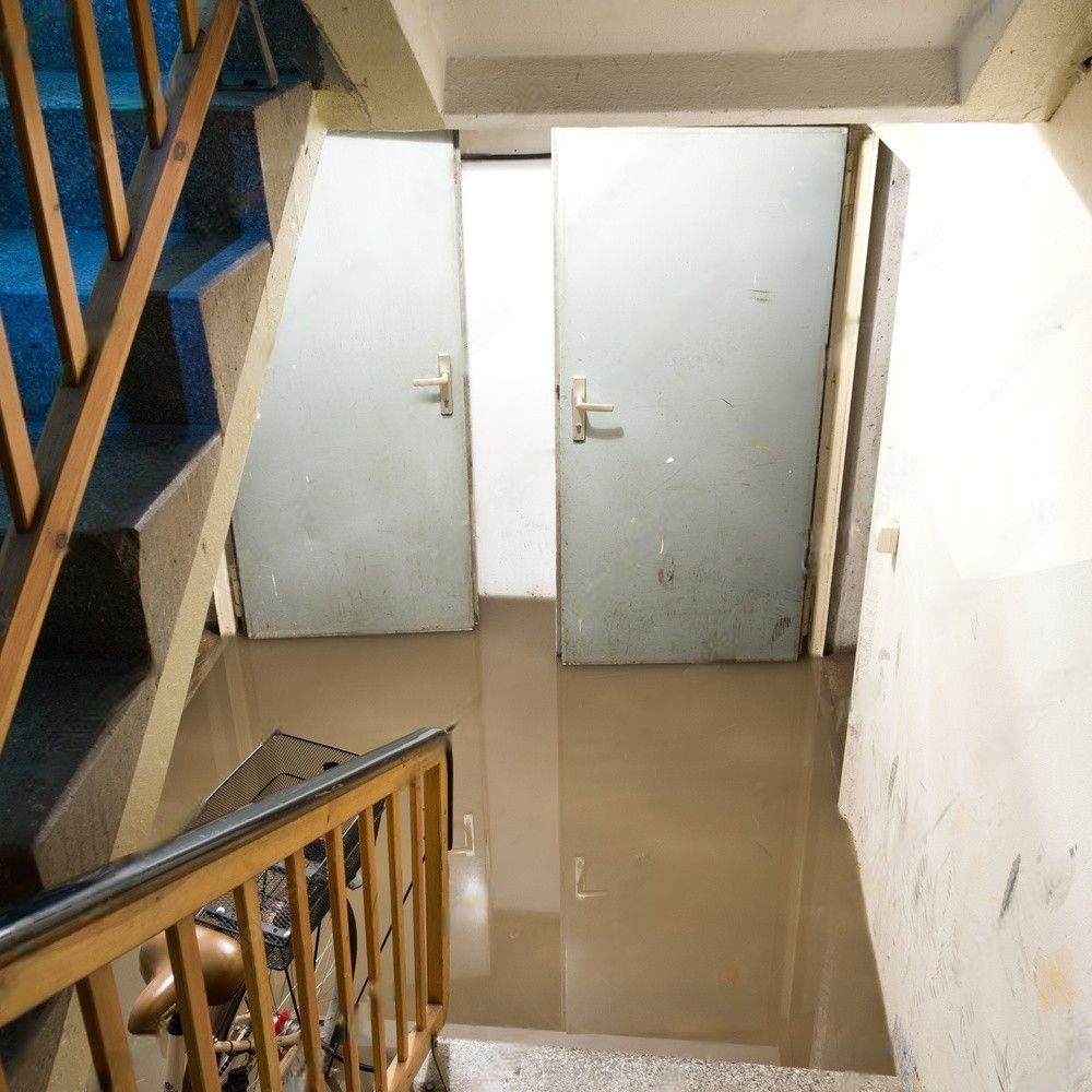 A flooded basement with water pooling on the floor.