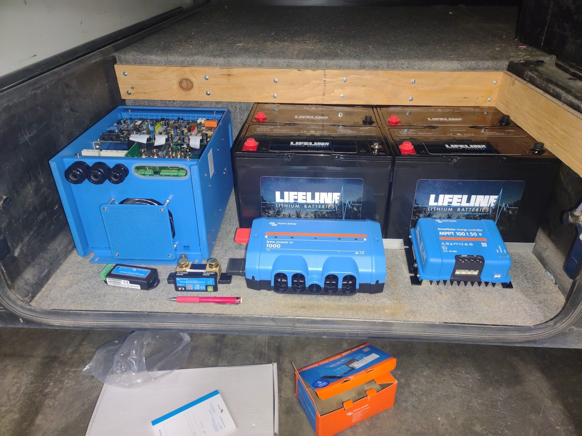 Victron inverter, charge controller, and lifeline batteries ready to be installed