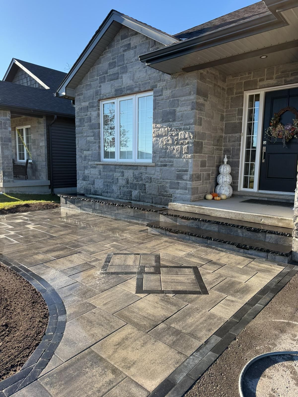 a patio with a circular design and a table and chairs