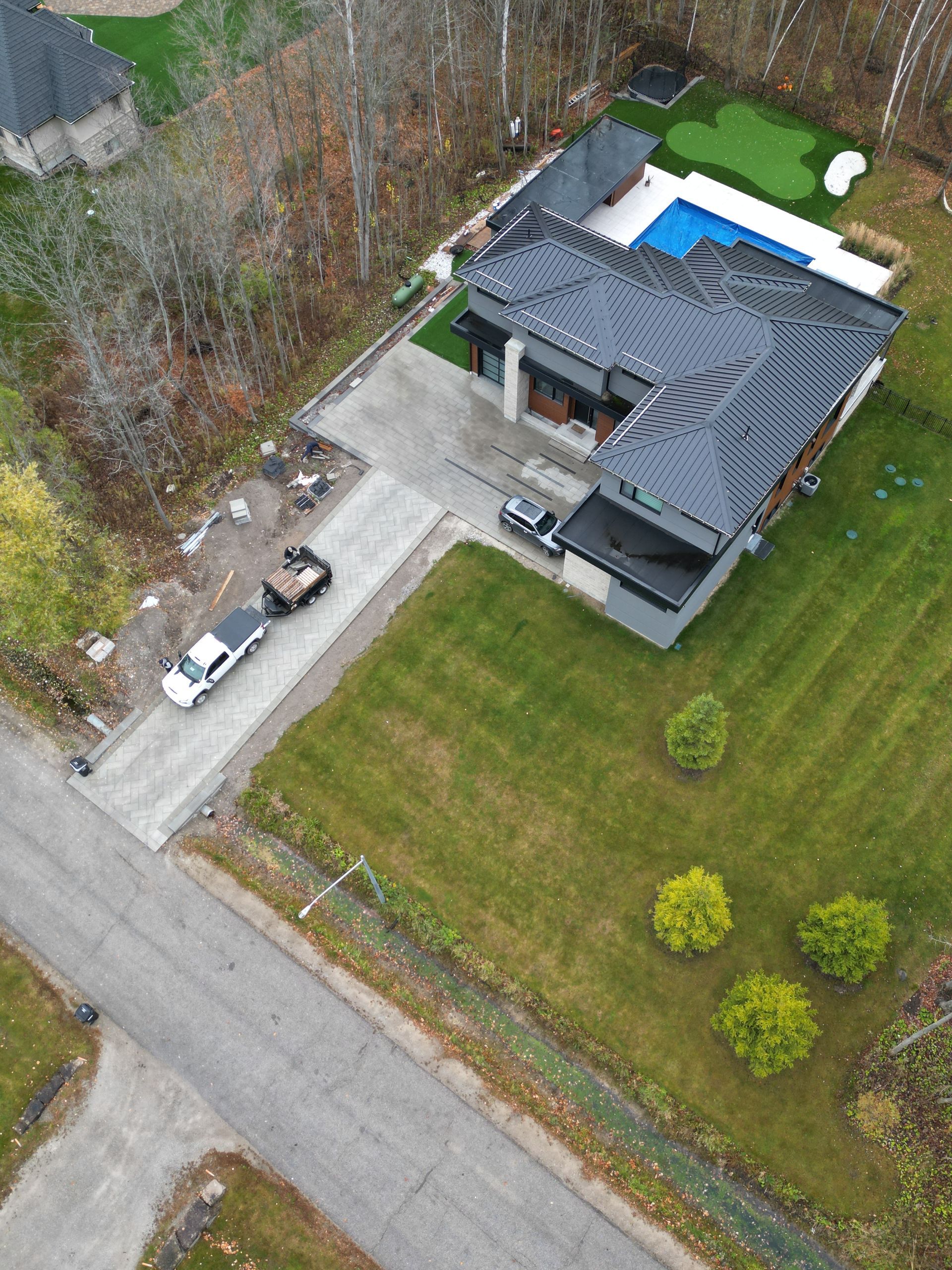 An aerial view of a house with a pool in the backyard.