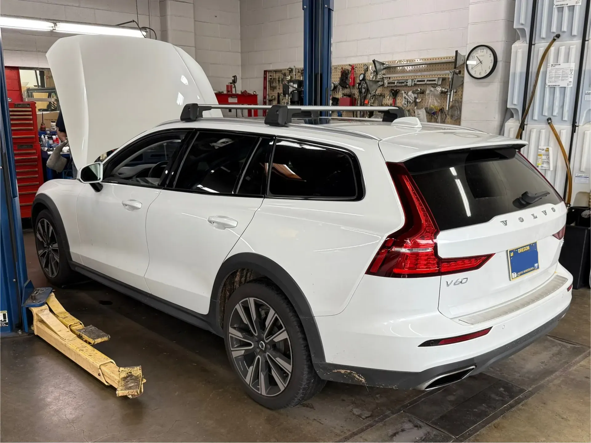 White Volvo Station Wagon in a Repair Shop | The V Shop