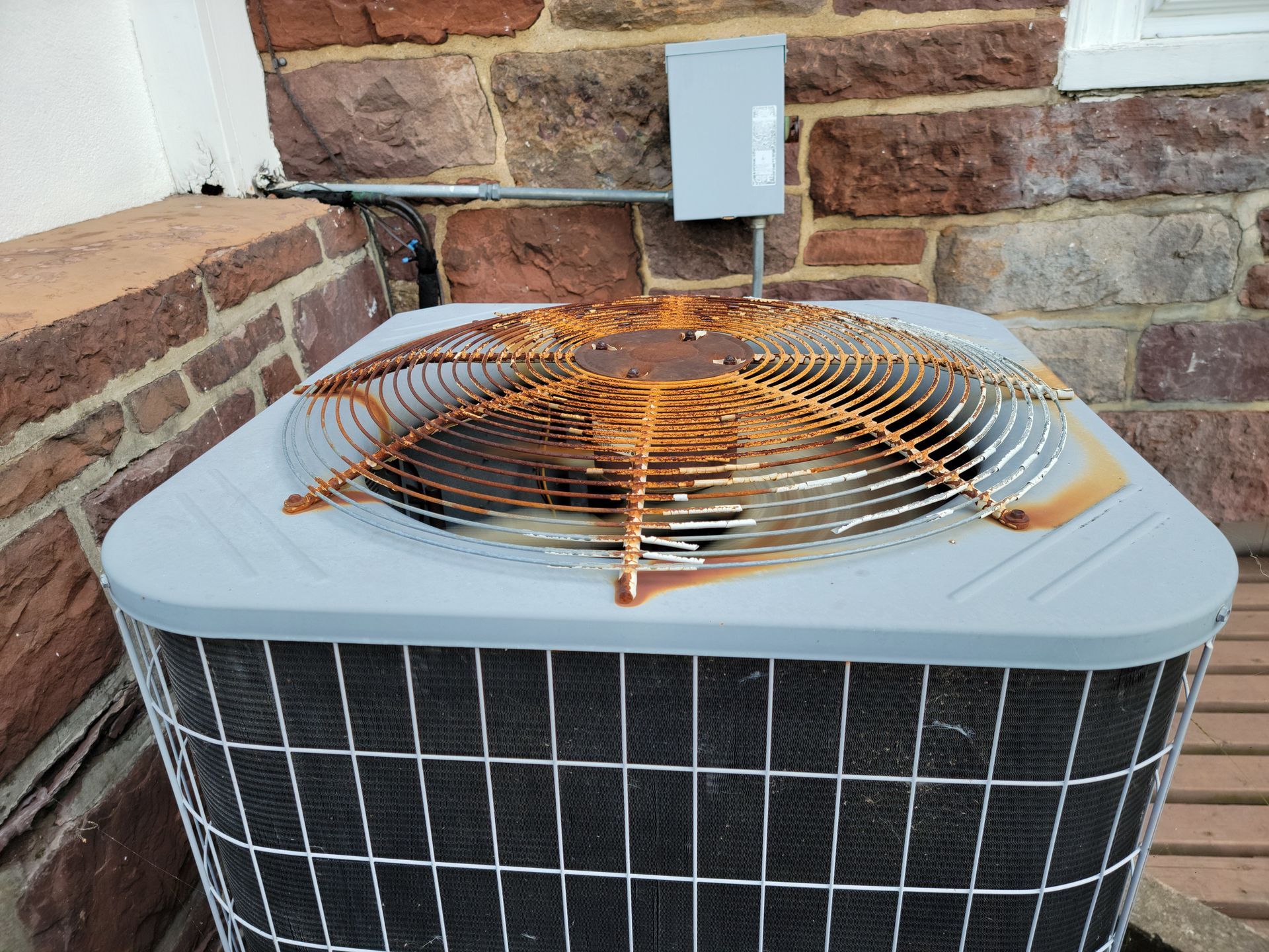 Rust on metal on air conditioning unit or machine outside.