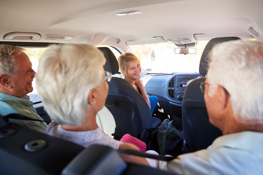 Four Older Adults in a Car — Dave's Drive U Anywhere 24/7 Mini Van Hire In Albion Park, NSW