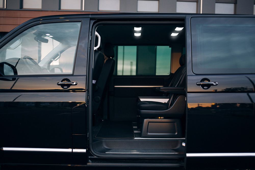 Black Van With Open Side Door — Dave's Drive U Anywhere 24/7 Mini Van Hire In Wollongong, NSW