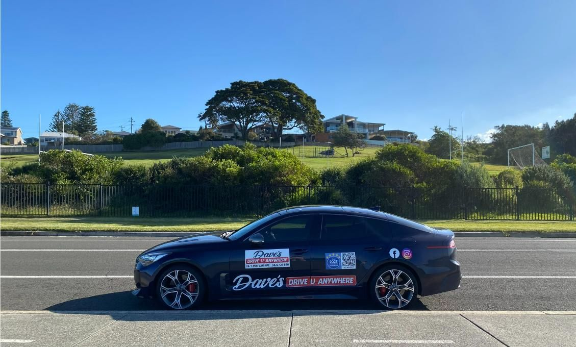Dark Blue Sedan Parked on a Road — Dave's Drive U Anywhere 24/7 Mini Van Hire In Austinmer, NSW