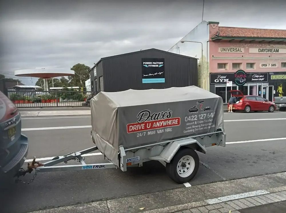 A Trailer Is Parked on The Side of The Road — Daves Drive U Anywhere in Wollongong, NSW