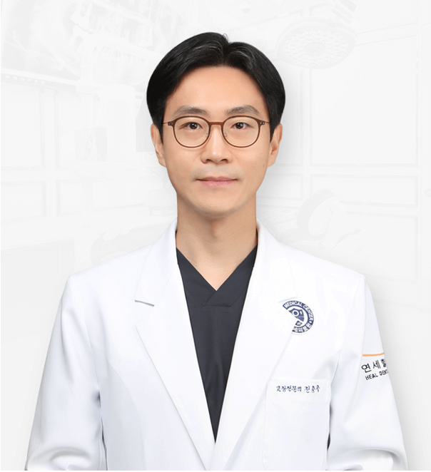 Man wearing glasses and a white lab coat, likely a doctor, in a clinical setting.