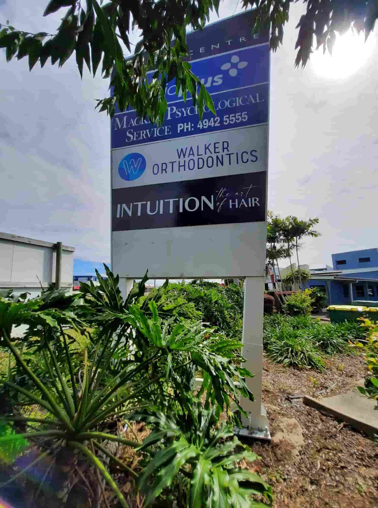A Large Sign Is Sitting In The Middle Of A Lush Green Field — Sun City Signs In Moranbah, QLD