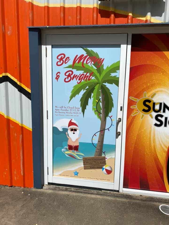 A Door With A Picture Of Santa On It And The Words Be Merry And Bright — Sun City Signs In Paget, QLD