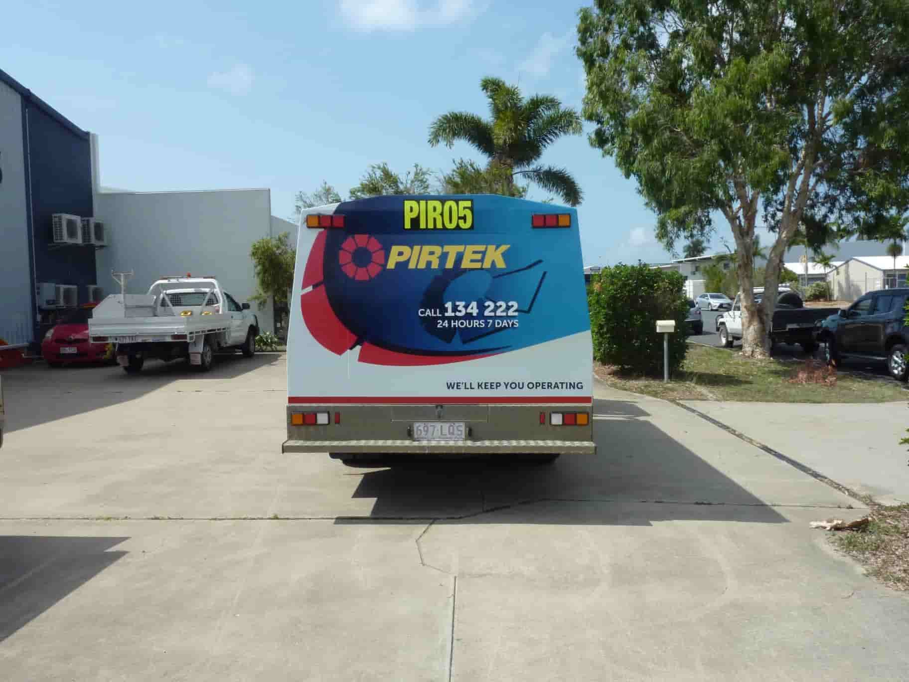 A White And Blue Piro5 Pirtek Truck Is Parked In A Parking Lot — Sun City Signs In Moranbah, QLD