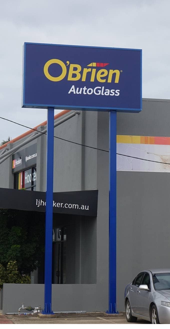 A Blue Sign For O'brien Autoglass Is In Front Of A Building — Sun City Signs In Moranbah, QLD