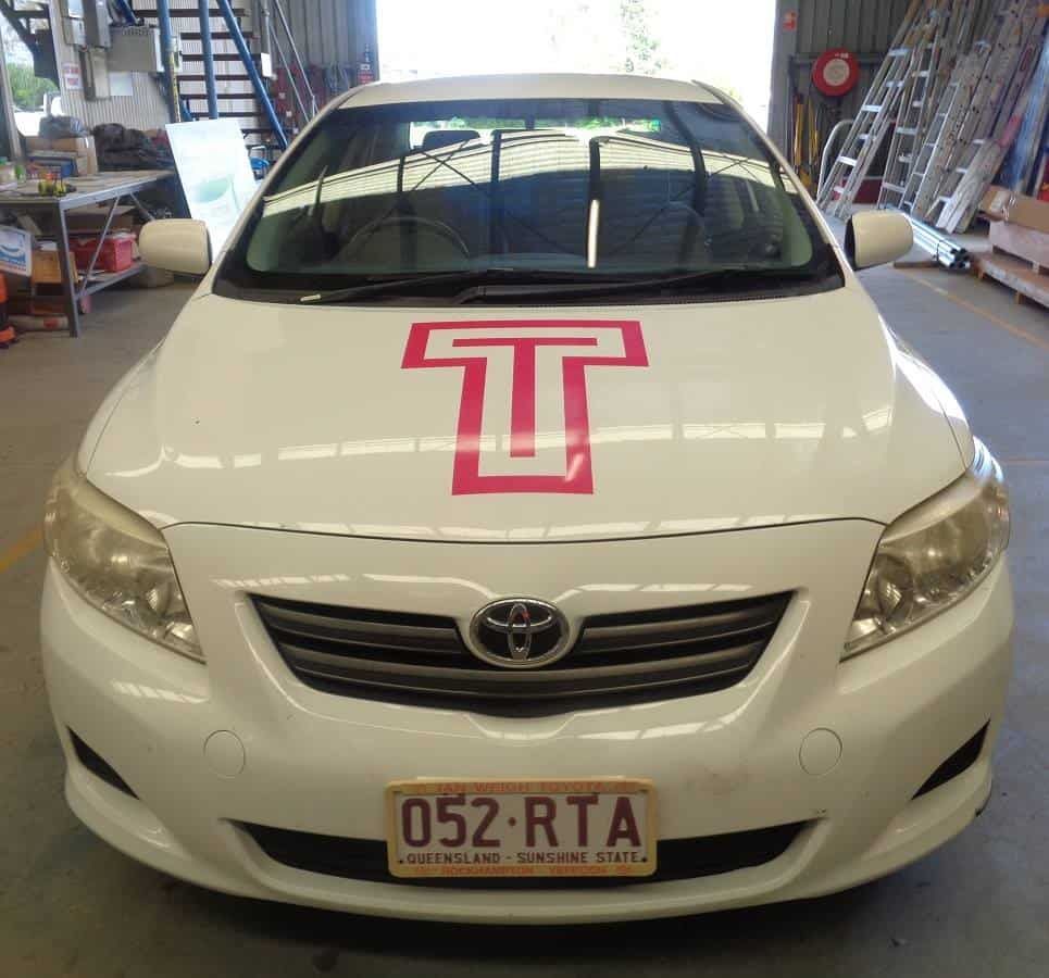 A White Toyota Car With A Red T On The Hood — Sun City Signs In Dysart, QLD