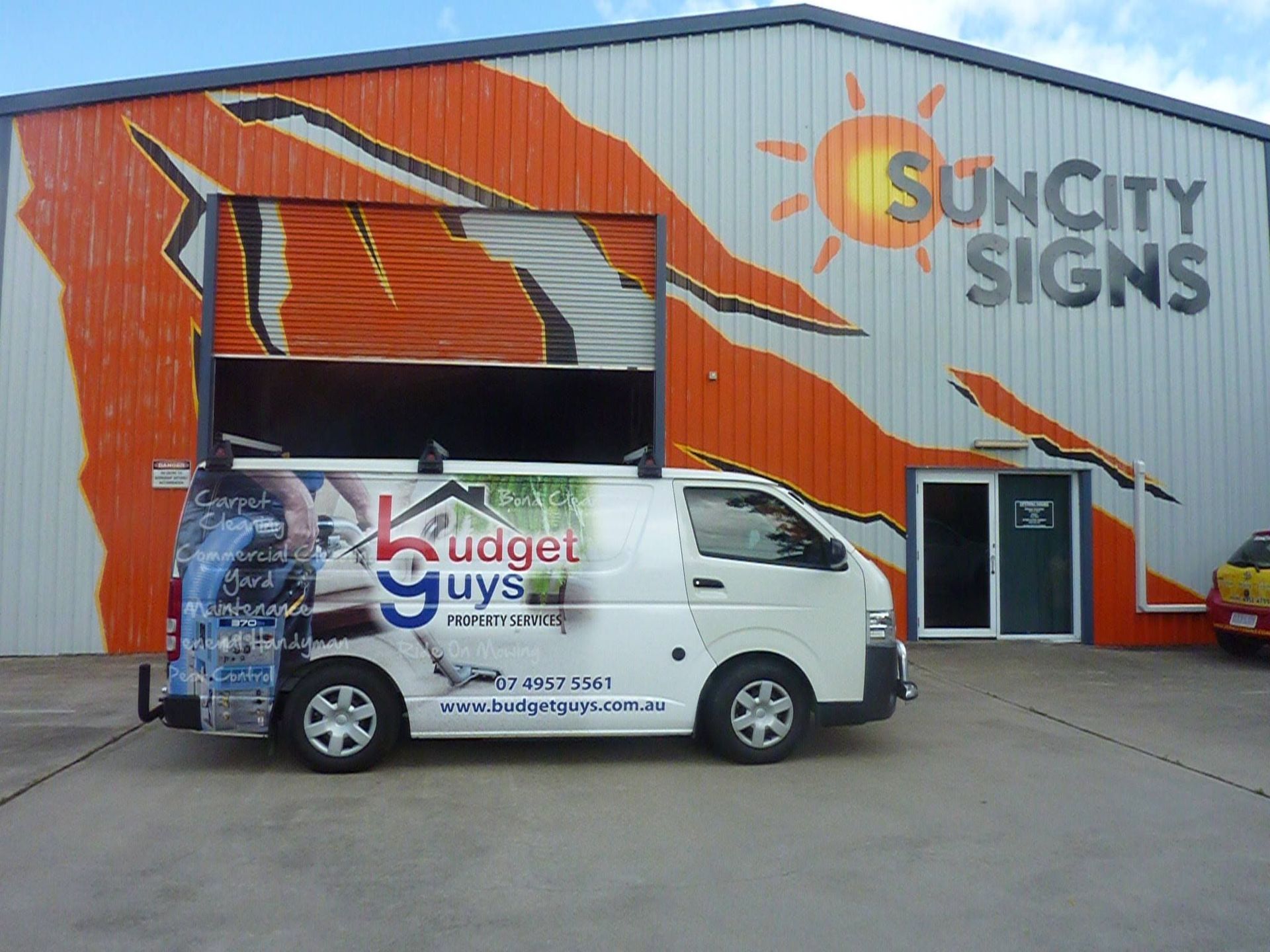 A White Van is Parked in Front of a Building That Says Suncity Signs — Sun City Signs In Paget, QLD