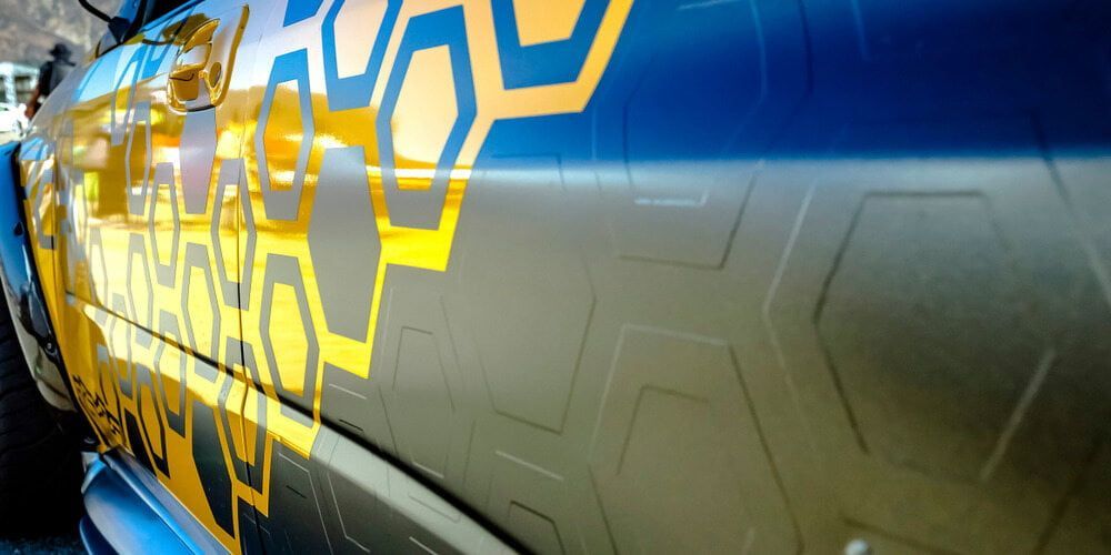 A Blue And Yellow Car With A Honeycomb Design On The Side — Sun City Signs In Paget, QLD