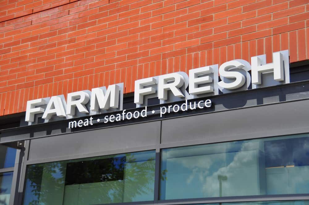 A Sign For Farm Fresh Meat Seafood Produce Is On A Brick Building — Sun City Signs In Dysart, QLD