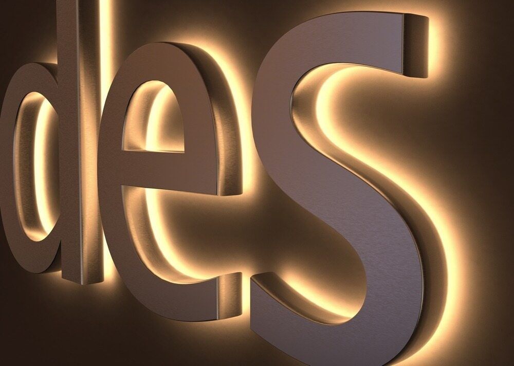 The Word Des Is Lit Up On A Brown Background — Sun City Signs In Paget, QLD