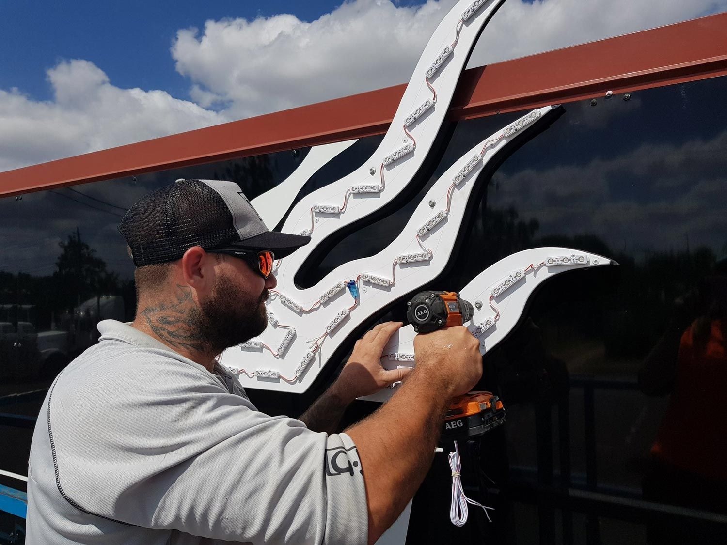 Man Installing An Illuminated Signage
