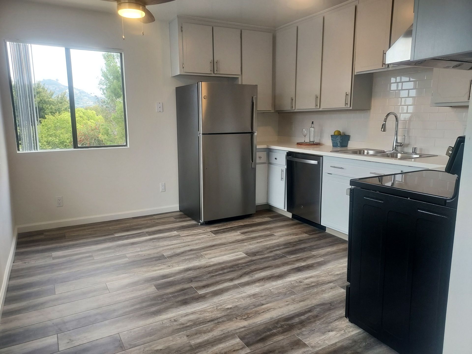 A kitchen with stainless steel appliances and white cabinets