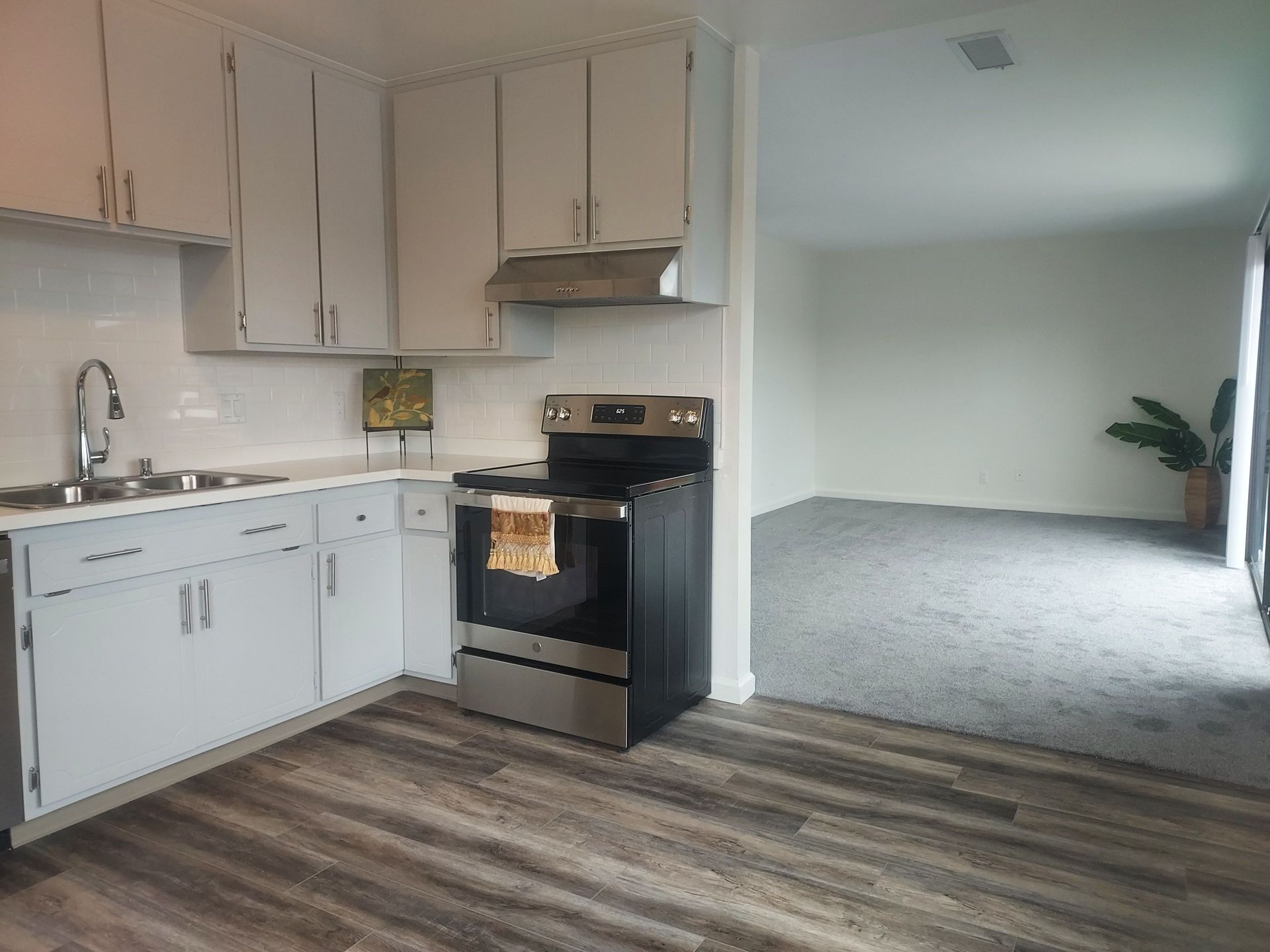 A kitchen with stainless steel appliances and white cabinets