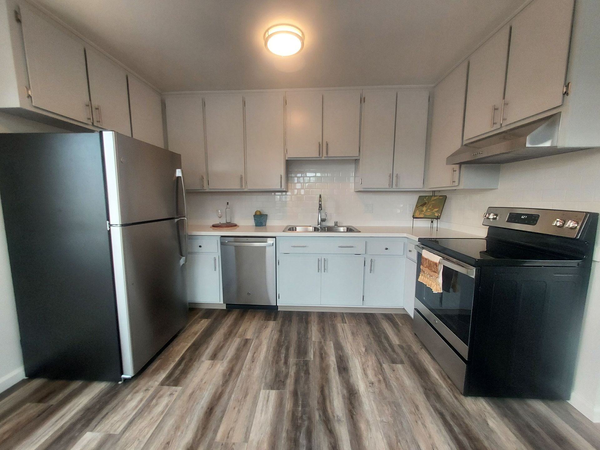 A kitchen with a refrigerator , stove , dishwasher and sink.