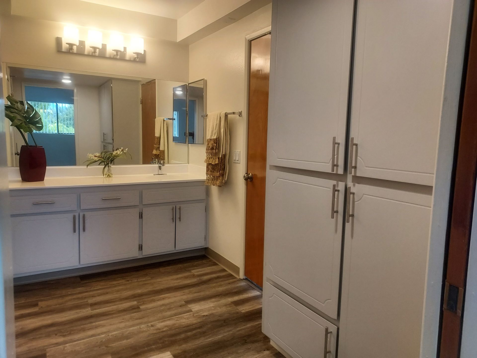 A bathroom with two sinks and a large mirror.