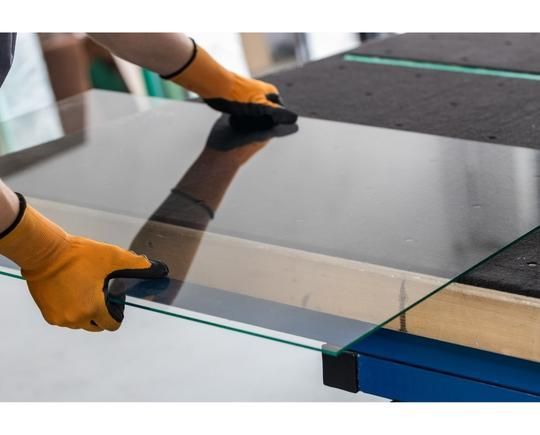 Measuring glass to be cut to size.