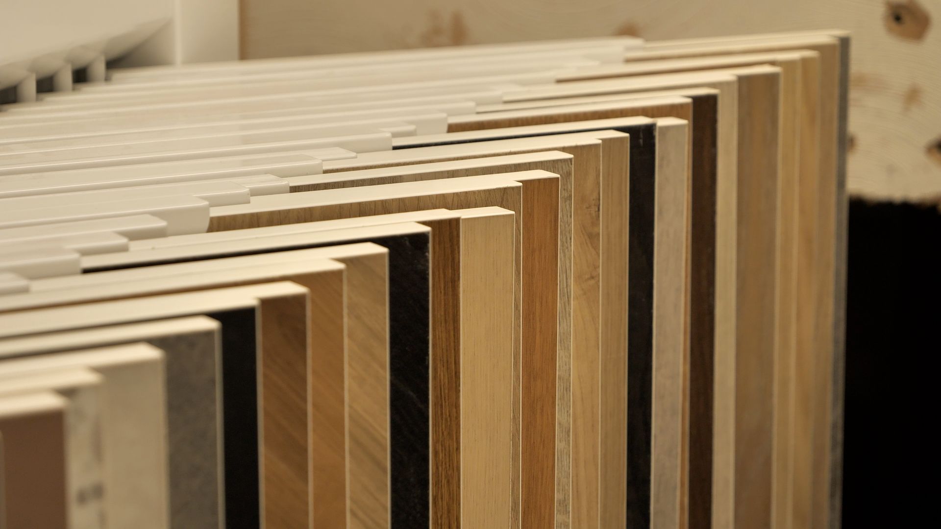 Man opening a pantry door filled with food and containers. Interior kitchen setting.