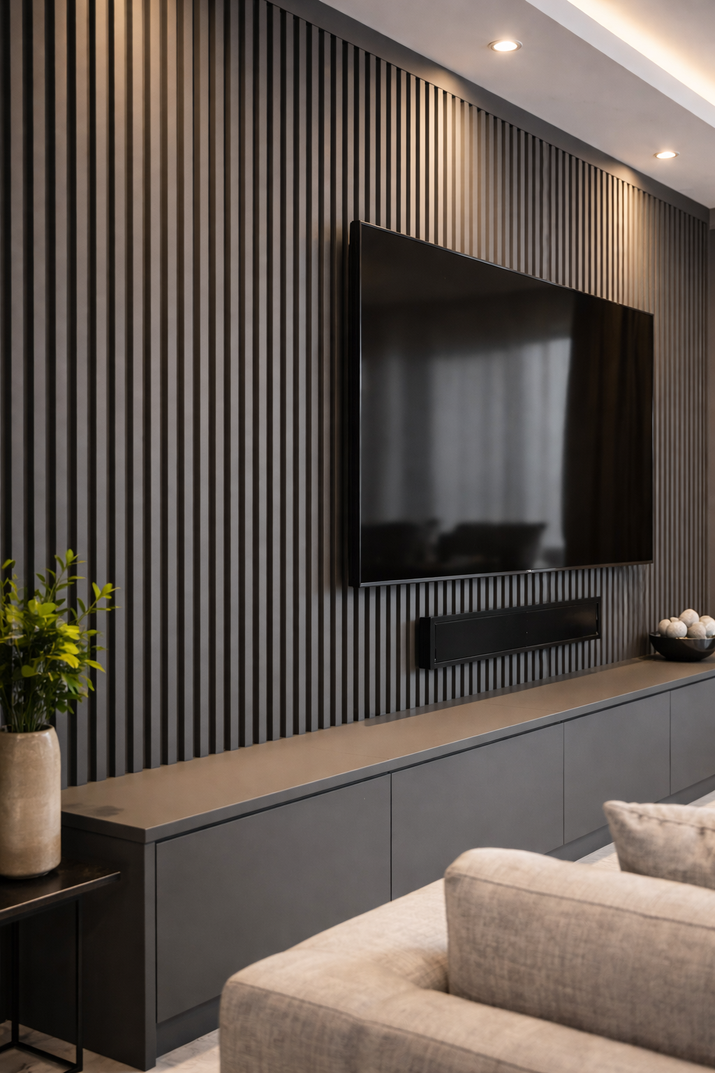 Modern living room with a gray slat wall, mounted TV, and built-in cabinet.