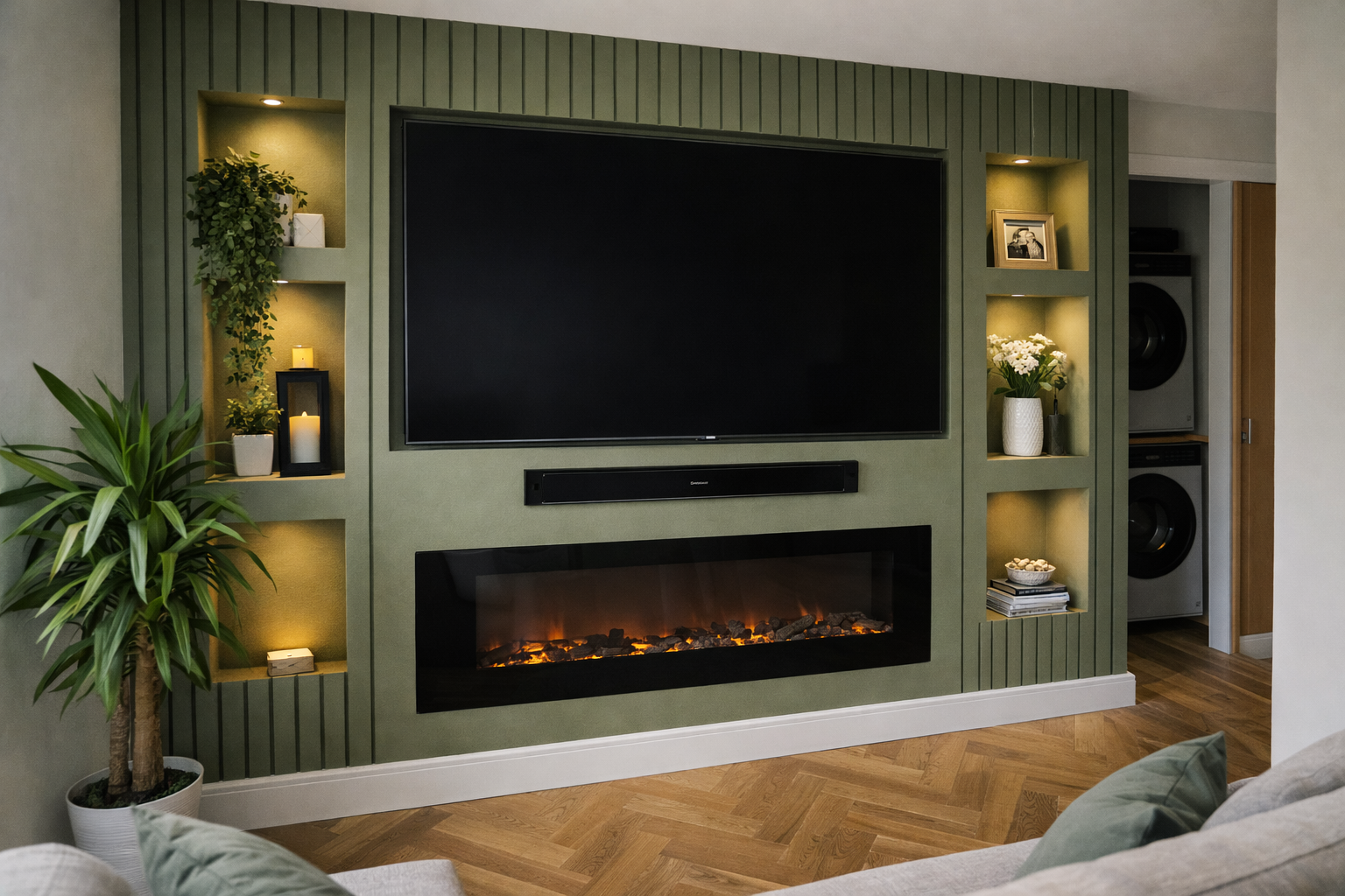 Green accent wall with built-in TV, fireplace, and shelving.