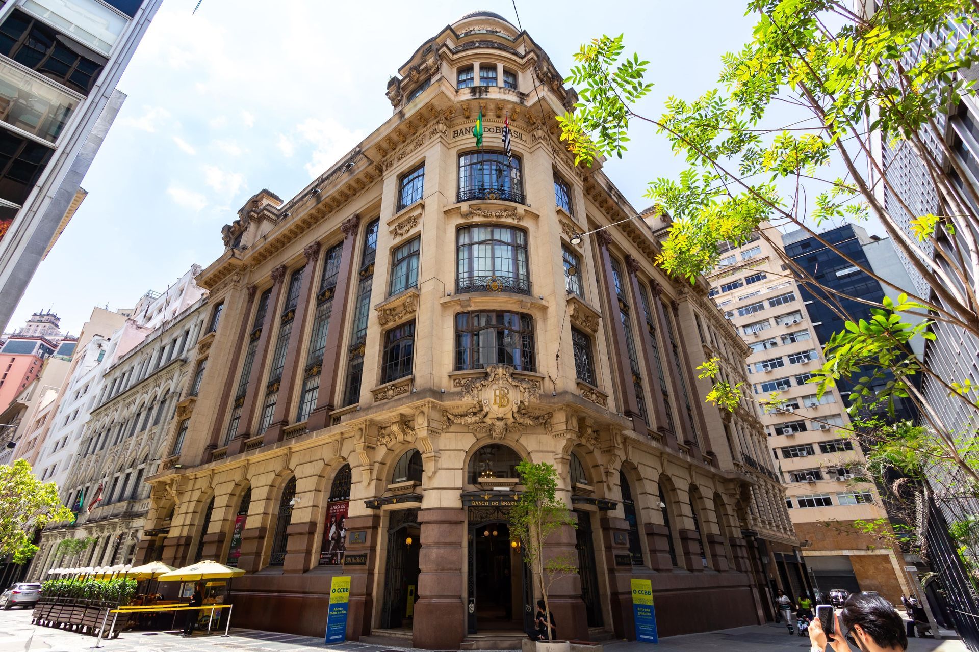 A large building with a lot of windows is in the middle of a city.