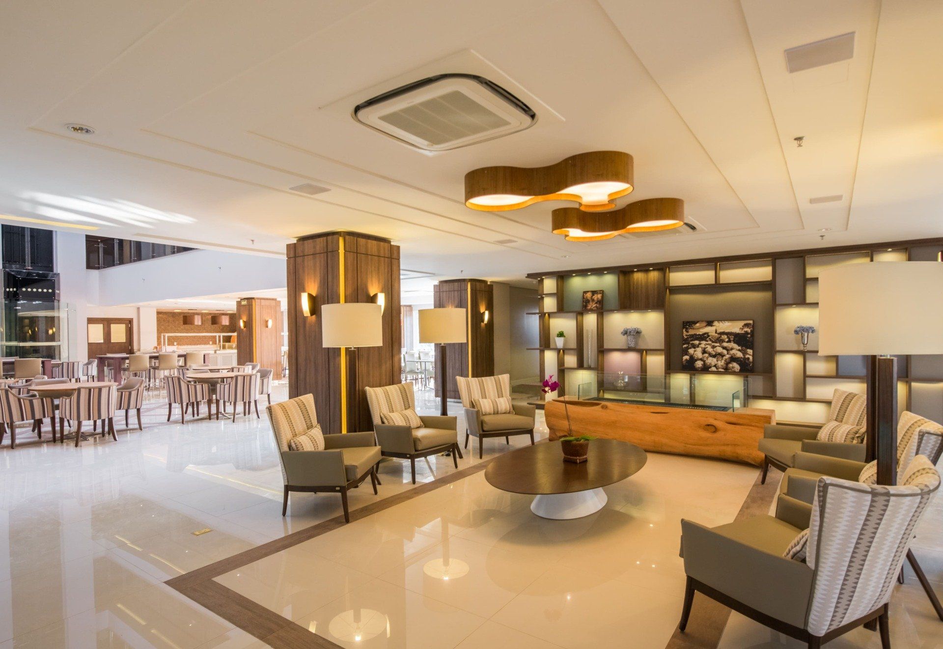 Spacious lobby with seating areas, wooden accents, and contemporary lighting.