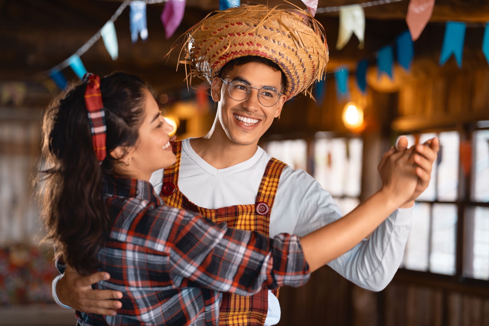 A man and a woman are dancing together at a party.